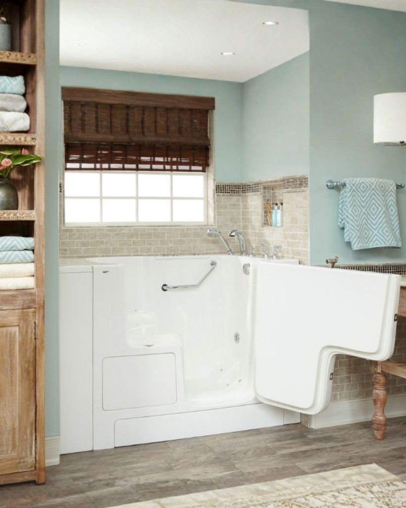 Walk-in tub installation by The Bath Authority with outward-swinging door, safety grab bar, hydrotherapy features, and accessible bathroom design for seniors and individuals with mobility needs.