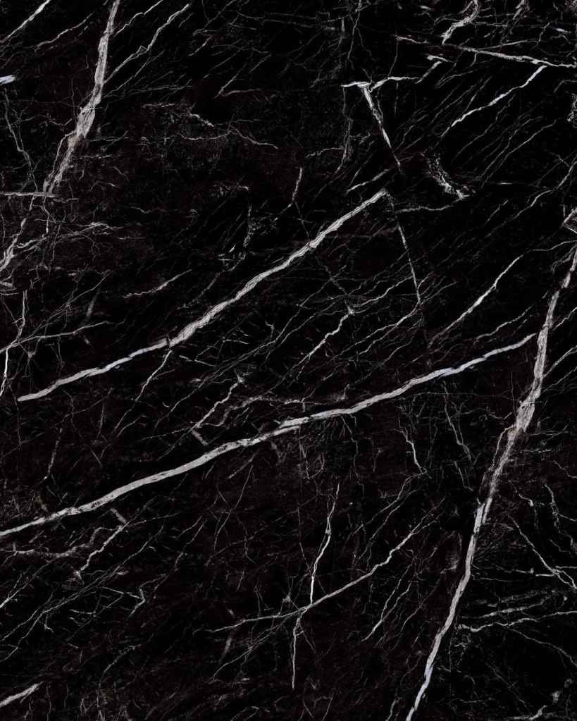 Black marble-look engineered stone shower wall panel or vanity countertop with dramatic white veining, installed by The Bath Authority for a modern luxury bathroom remodel.