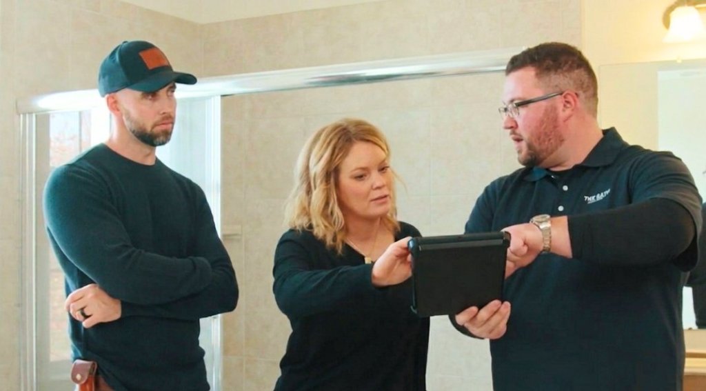 A Design Consultant from The Bath Authority explains options to a homeowner.